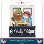 A DIY kit for creating a nativity scene, featuring a wooden frame with a nativity scene and two wooden figures representing the baby Jesus and Mary.