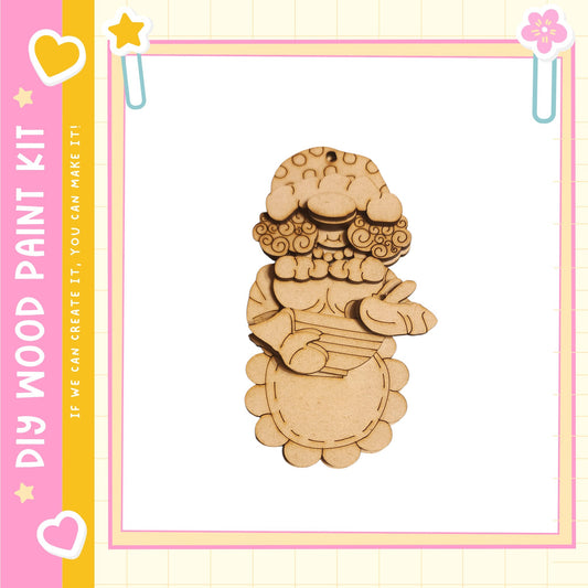 a wooden ornament with a whimsical design, including a star and a flower, set against a pink and yellow background.