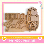 a DIY wood paint kit with a wooden sign that says "Hello fall" and a wooden pumpkin decoration.
