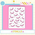 a white stencil with a pattern of pink bats on a pink background.
