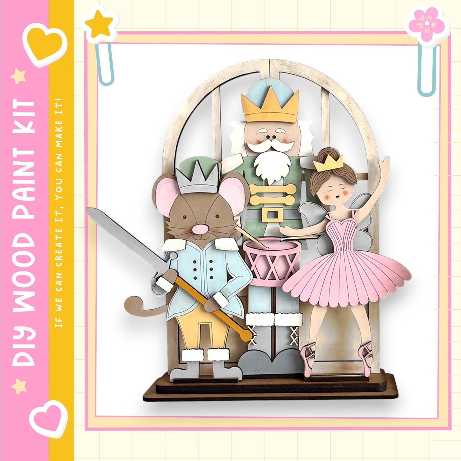 A wooden nutcracker figure holding a sword and a mouse figure, with a young girl figure in a pink dress standing next to them.