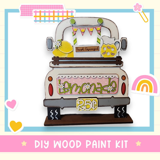 The image is a colorful and whimsical DIY wood paint kit featuring a lemonade-themed truck decoration.