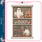 The image is a Halloween-themed decoration featuring a wooden shelf with a ghost, a witch, pumpkins, and flowers. The shelf has the word "BOO" written on it.
