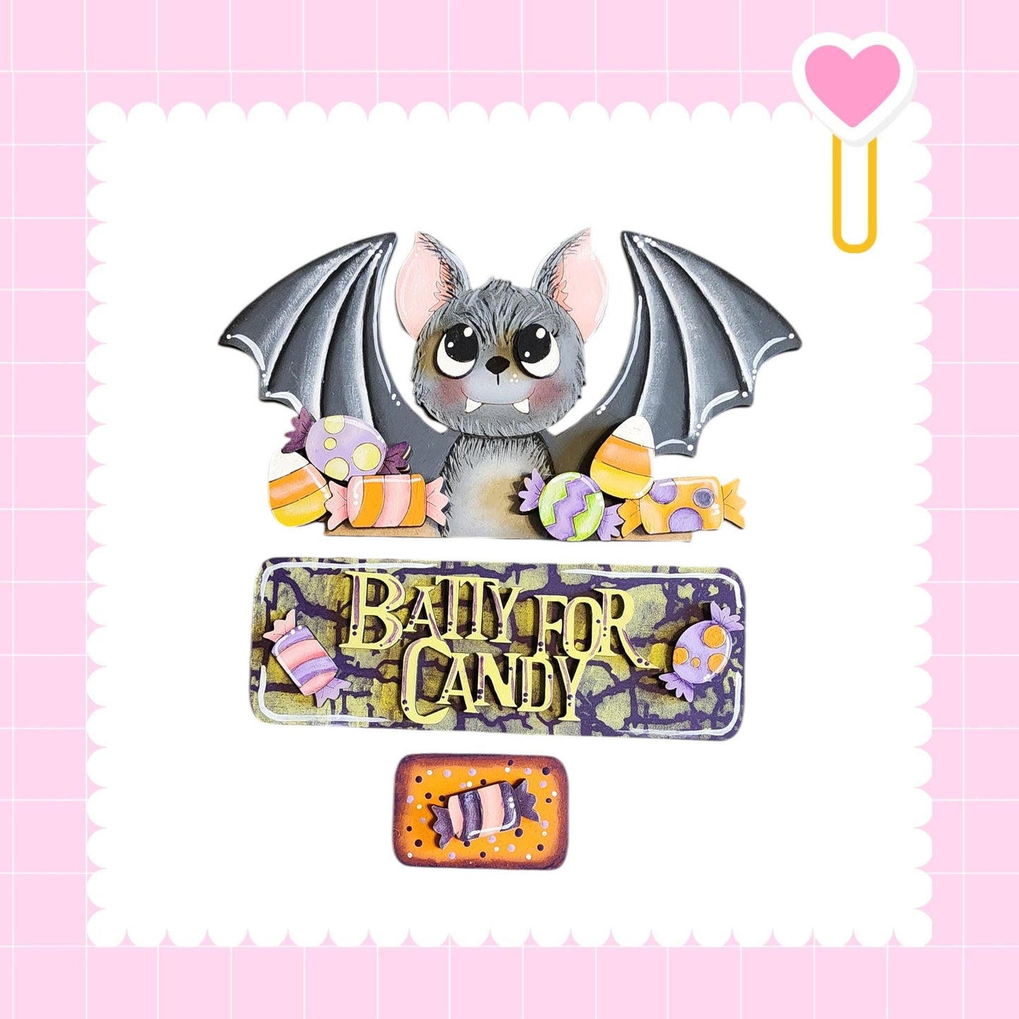 A bat with wings and a bat-like face is surrounded by various candy items, including a sign that says "Bally for Candy".