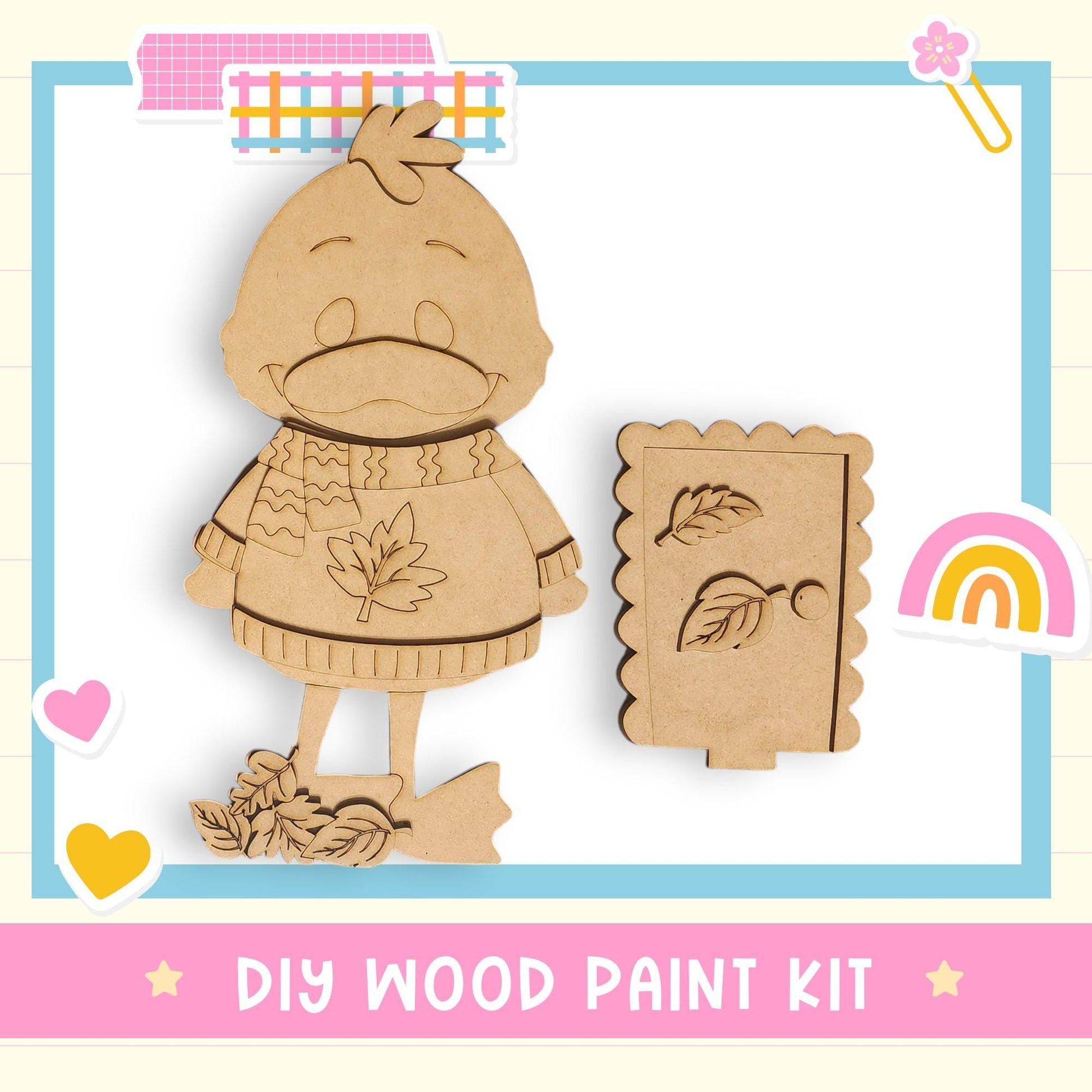 a DIY wood paint kit, including a wooden bird figure and a wooden leaf-shaped cutout, set against a background with a pink and blue border.