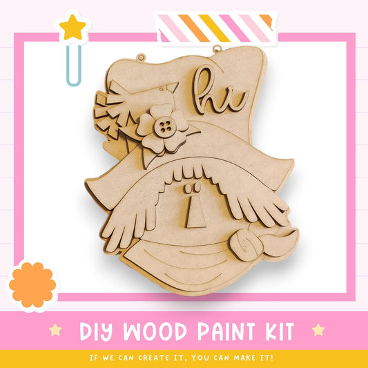 The image is a DIY wood paint kit advertisement, featuring a wooden cutout with a bird and flowers, along with a pink and white striped border.