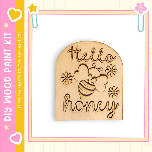 a wooden cutout with the text "Hello honey" carved into it, surrounded by a decorative border.