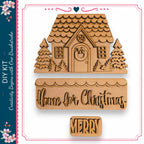 a wooden house with a wreath and a "Home for Christmas" sign, along with a "Merry" sign.