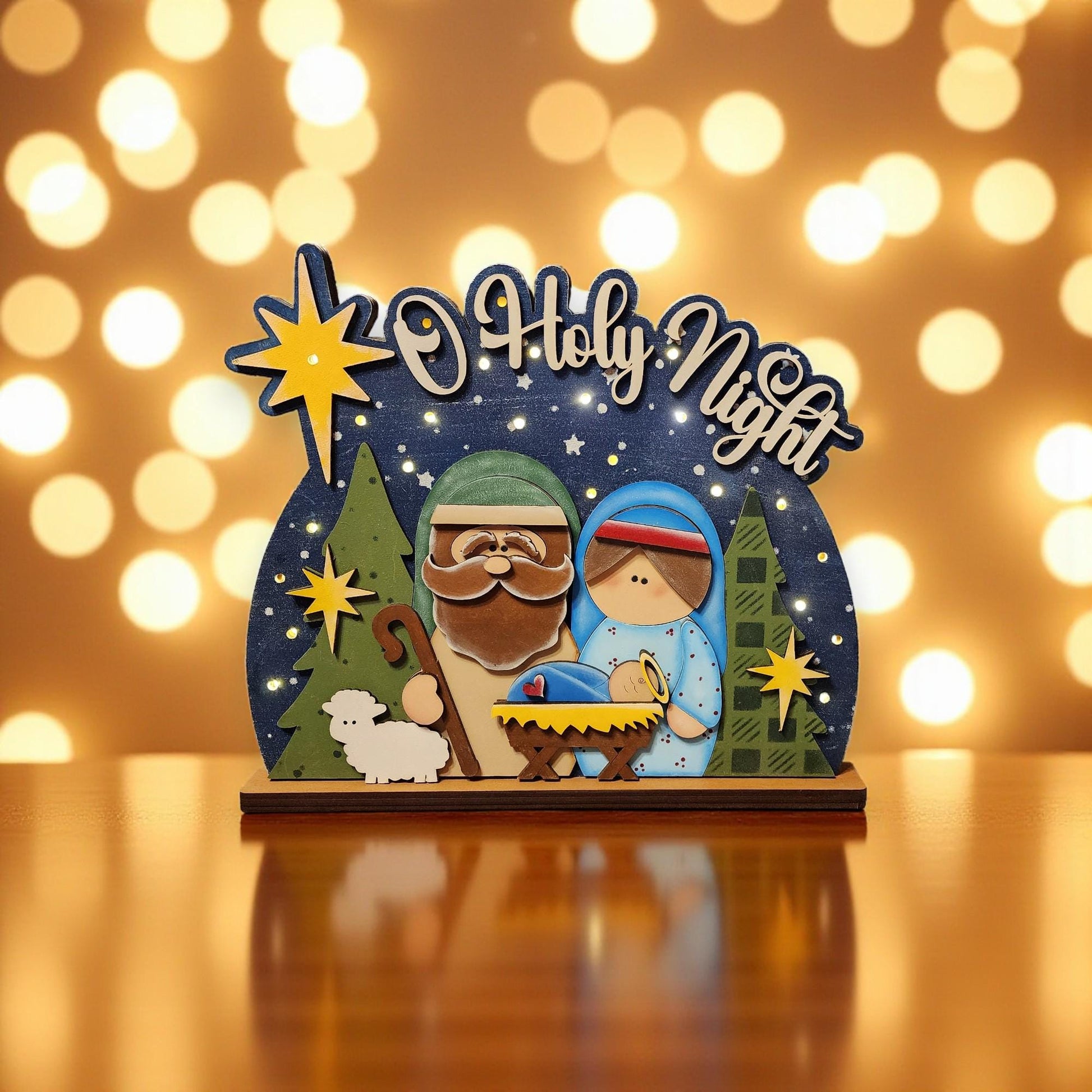 A wooden nativity scene with a man, a woman, and a baby, surrounded by holiday lights and stars.