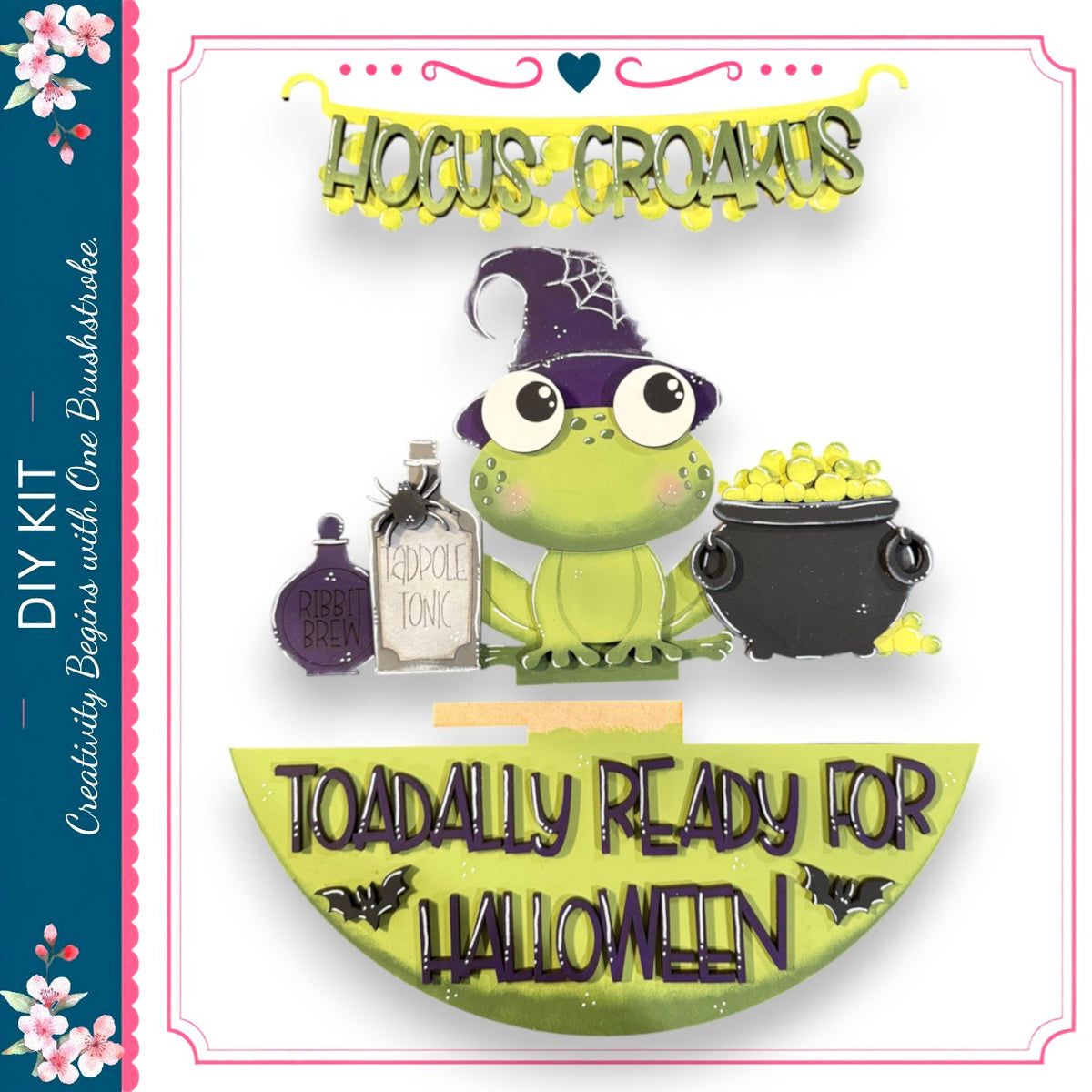 A green frog wearing a witch's hat and holding a cauldron, with the text "Hocus CROAMUS" and "TOADALLY READY FOR HALLOWEEN" displayed.