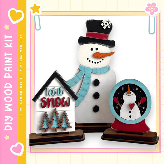 A snowman and a snow globe are displayed in the image, along with a sign that says "let it snow".