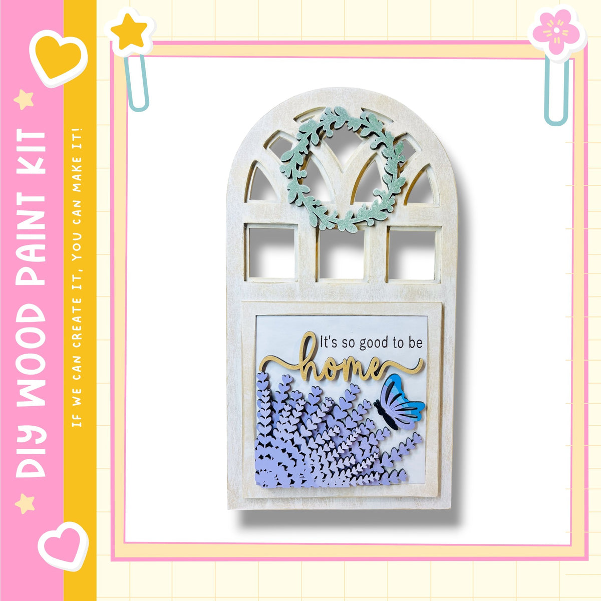 a wooden frame with a wreath and a butterfly design, set against a pink and yellow background.