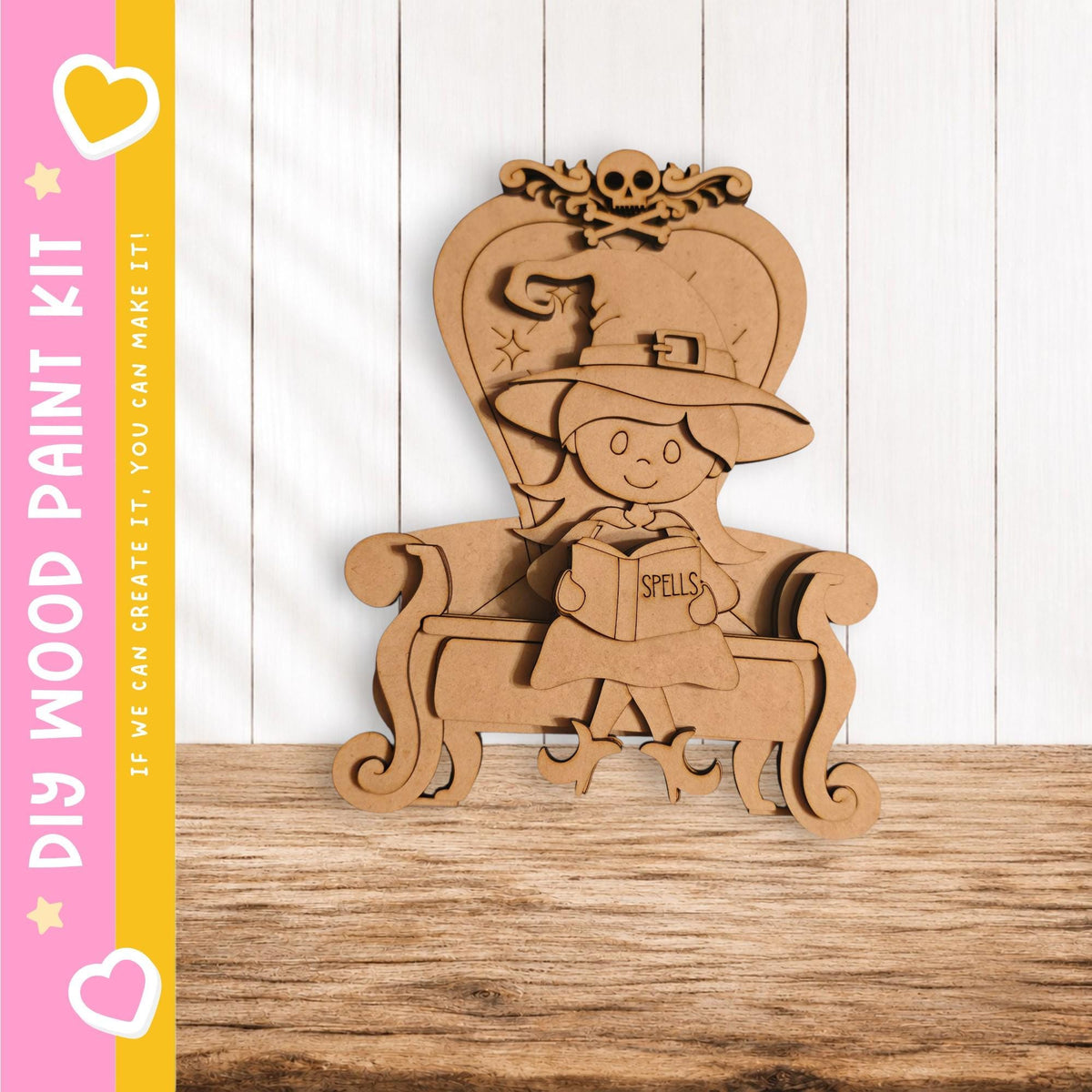 A wooden cutout of a witch sitting in a chair, holding a book titled "SPELLS".