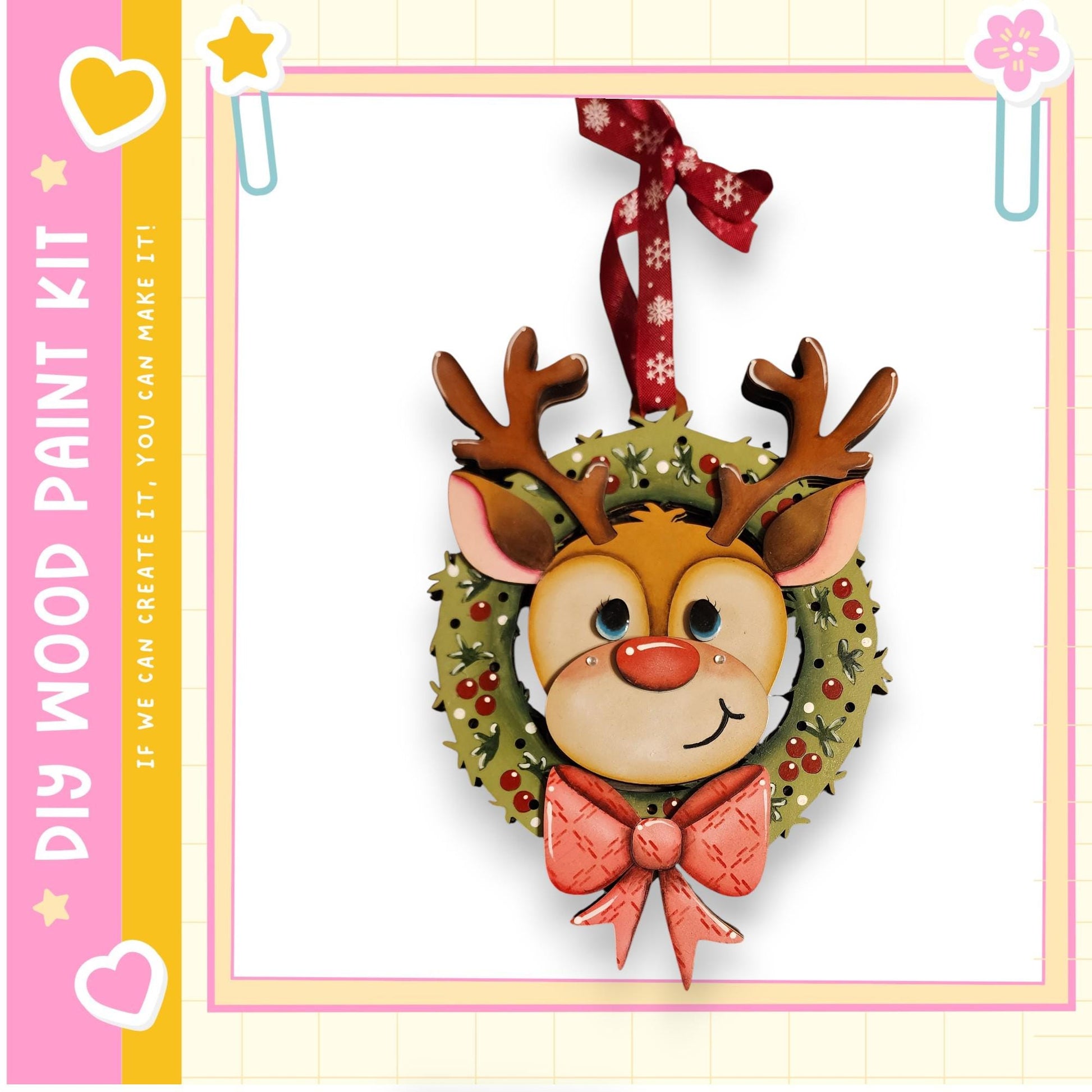 A festive wreath with a smiling reindeer face, adorned with a red bow, hangs on a wall.