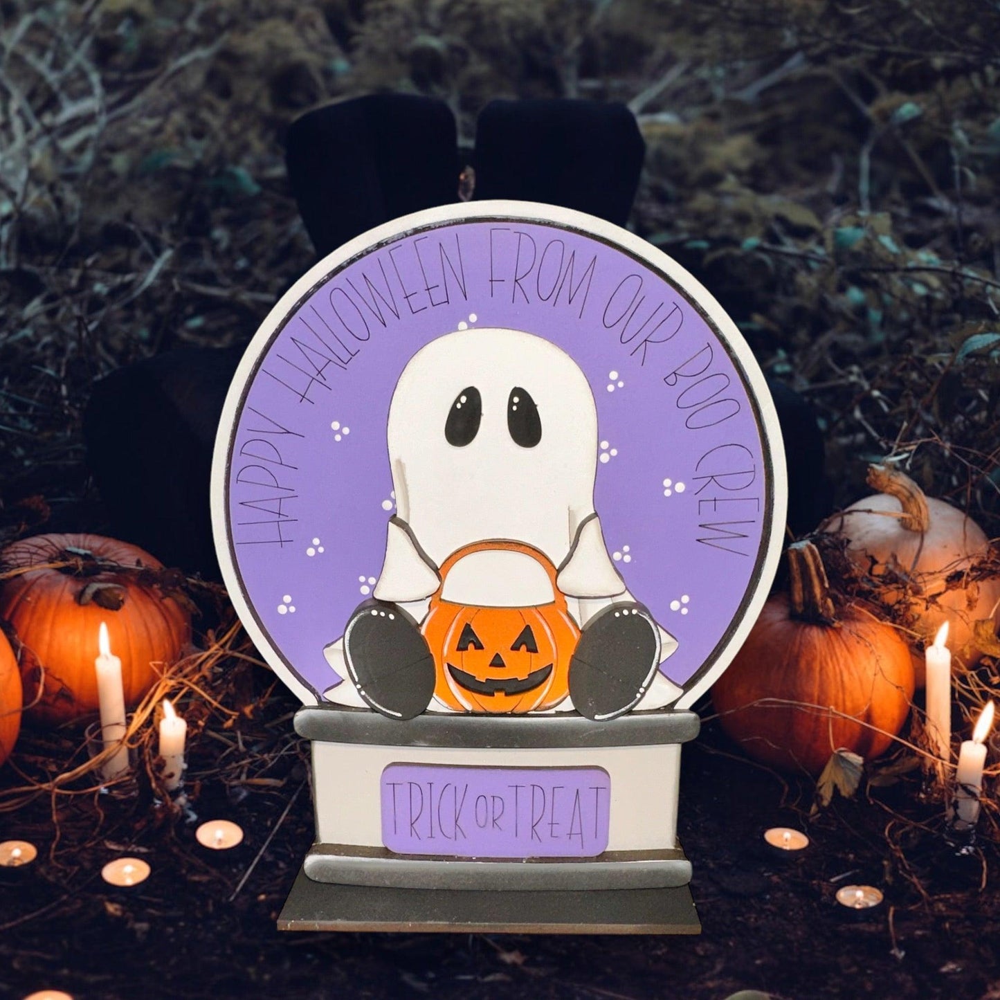 a halloween decoration with a ghost holding a pumpkin