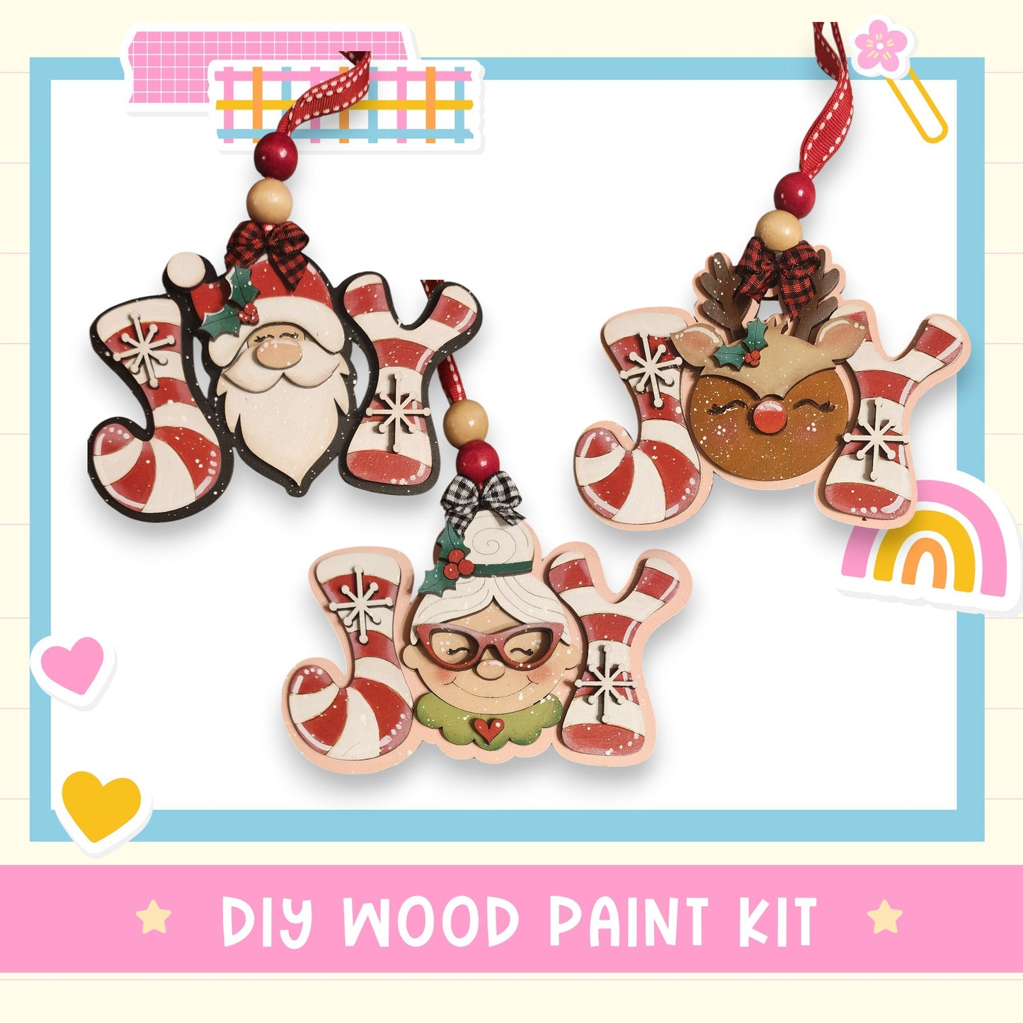 three wooden ornaments hanging from a string, each with a unique design and color scheme. The ornaments include a Santa Claus figure, a reindeer, and a smiling woman with glasses. The background of the image is white, and there is a pink banner at the bottom that reads "DIY WOOD PAINT KIT".