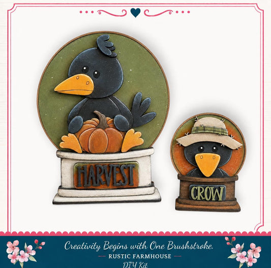 two bird-shaped decorations, one larger and one smaller, both with the word "HARVEST" written on them. The larger bird is sitting on a pumpkin, and the smaller bird is wearing a hat. The decorations are part of a rustic farmhouse-themed kit, as indicated by the text at the bottom of the image.