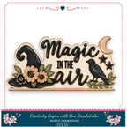 The image is a wooden sign with the text "Magic in the air" and decorative elements such as a witch's hat, flowers, and a bird.