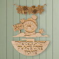 A wooden sign with the text "LET IT SNOW PLACE LIKE HOME" and a snowman figure, along with snowflakes and birds, is displayed against a light green background.