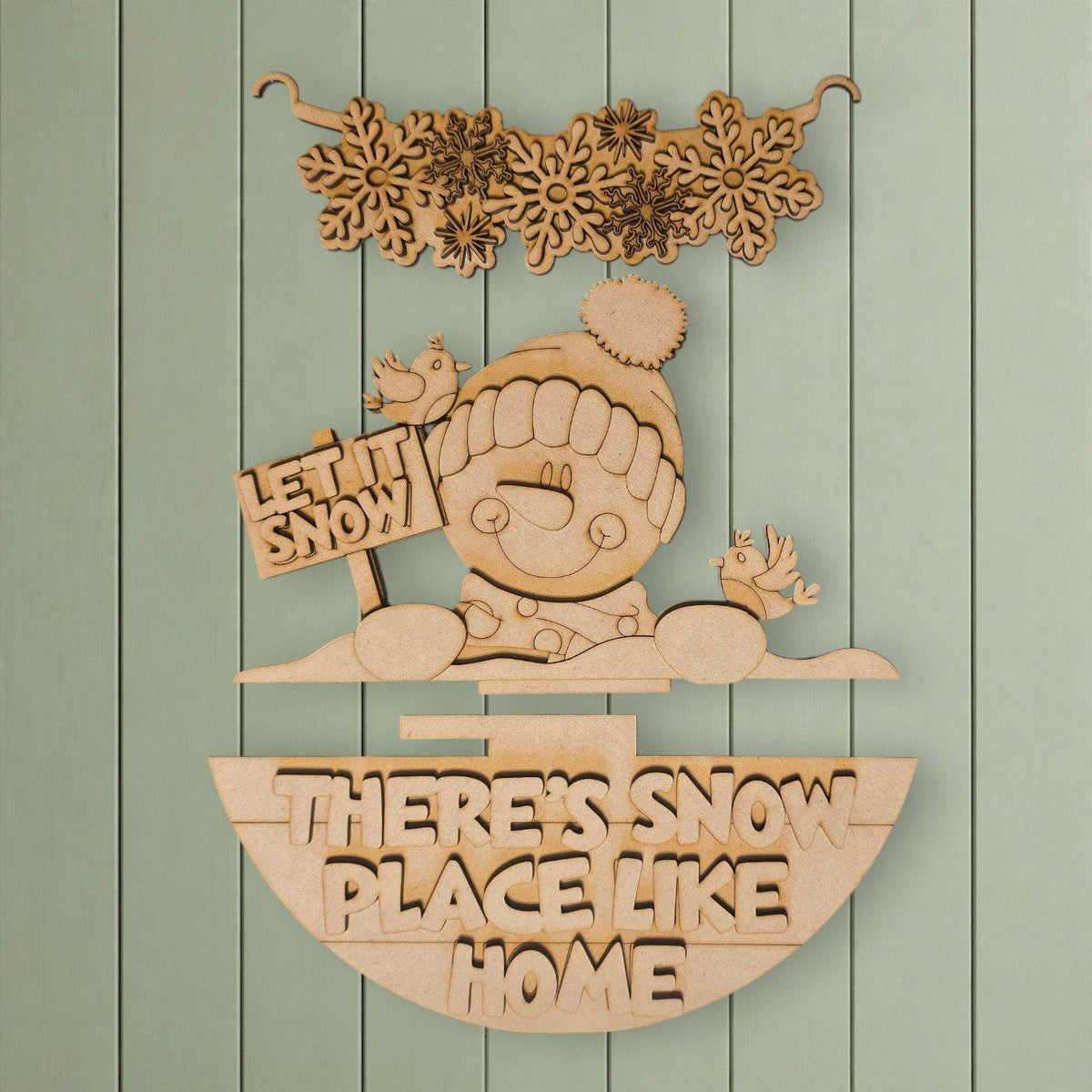 A wooden sign with the text "LET IT SNOW PLACE LIKE HOME" and a snowman figure, along with snowflakes and birds, is displayed against a light green background.