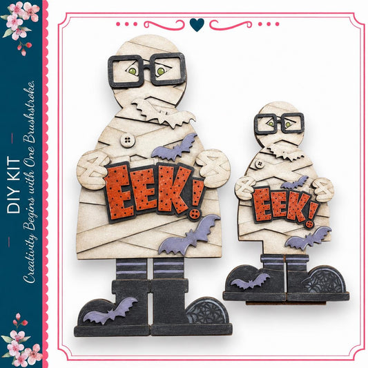 two wooden figures dressed as mummies, each holding a sign that says "EEEK!"