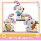 The image is a collage of three wooden Easter bunny figures, each holding a different Easter egg. The text below the image reads "DIY WOOD PAINT KIT" and "If we can create it, you can make it!"