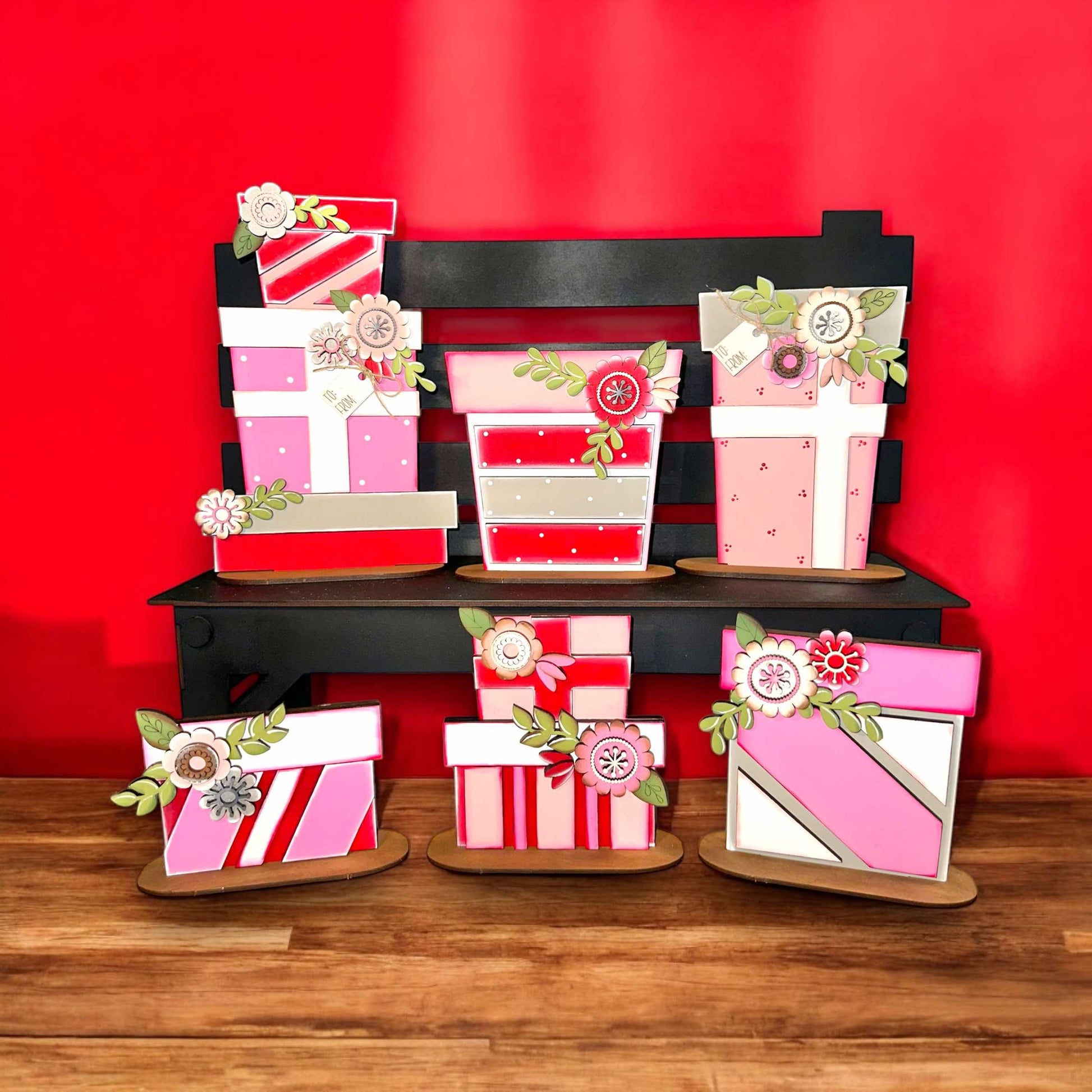 a stack of pink and red gift boxes