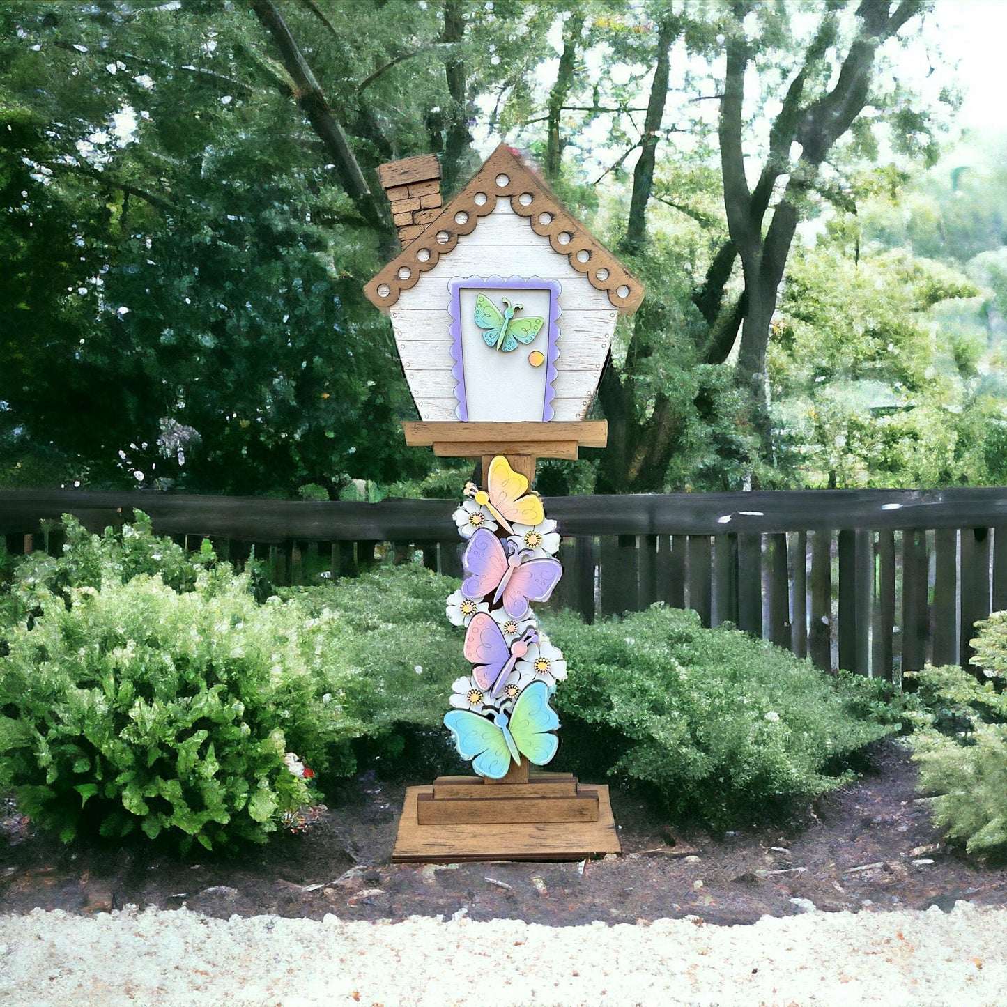 a colorful birdhouse on a wooden stand in a garden