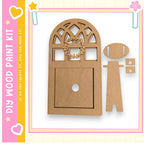 a wooden door with a wreath on top, and there are two smaller wooden pieces next to it. The image is part of a larger kit, as indicated by the text "My Wood Paint Kit" and "If we can create it, we can make it!"