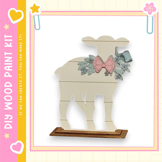 A wooden sheep figurine with a bow on its head, standing on a wooden base.