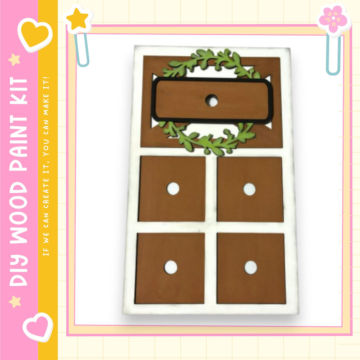 The image is a wooden paint kit featuring a wooden frame with four compartments, each with a hole, and a wreath decoration on top.