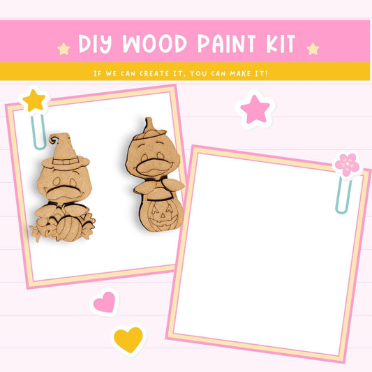 The image is a DIY wood paint kit featuring two wooden characters, likely representing a witch and a pumpkin, along with some decorative elements such as hearts and stars.