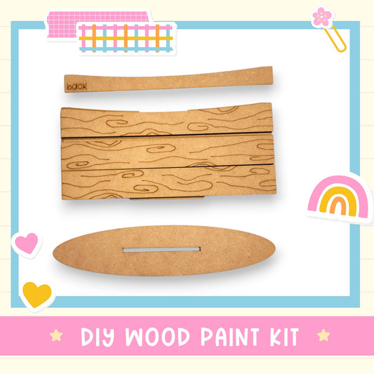 a wooden paint kit with a rainbow in the background