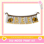 A DIY wood paint kit featuring a banner with the word "BEE" and illustrations of bees.