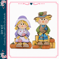 two wooden scarecrow figures, one with a purple dress and the other with a green plaid shirt and hat, sitting on a pile of hay and orange pumpkins.