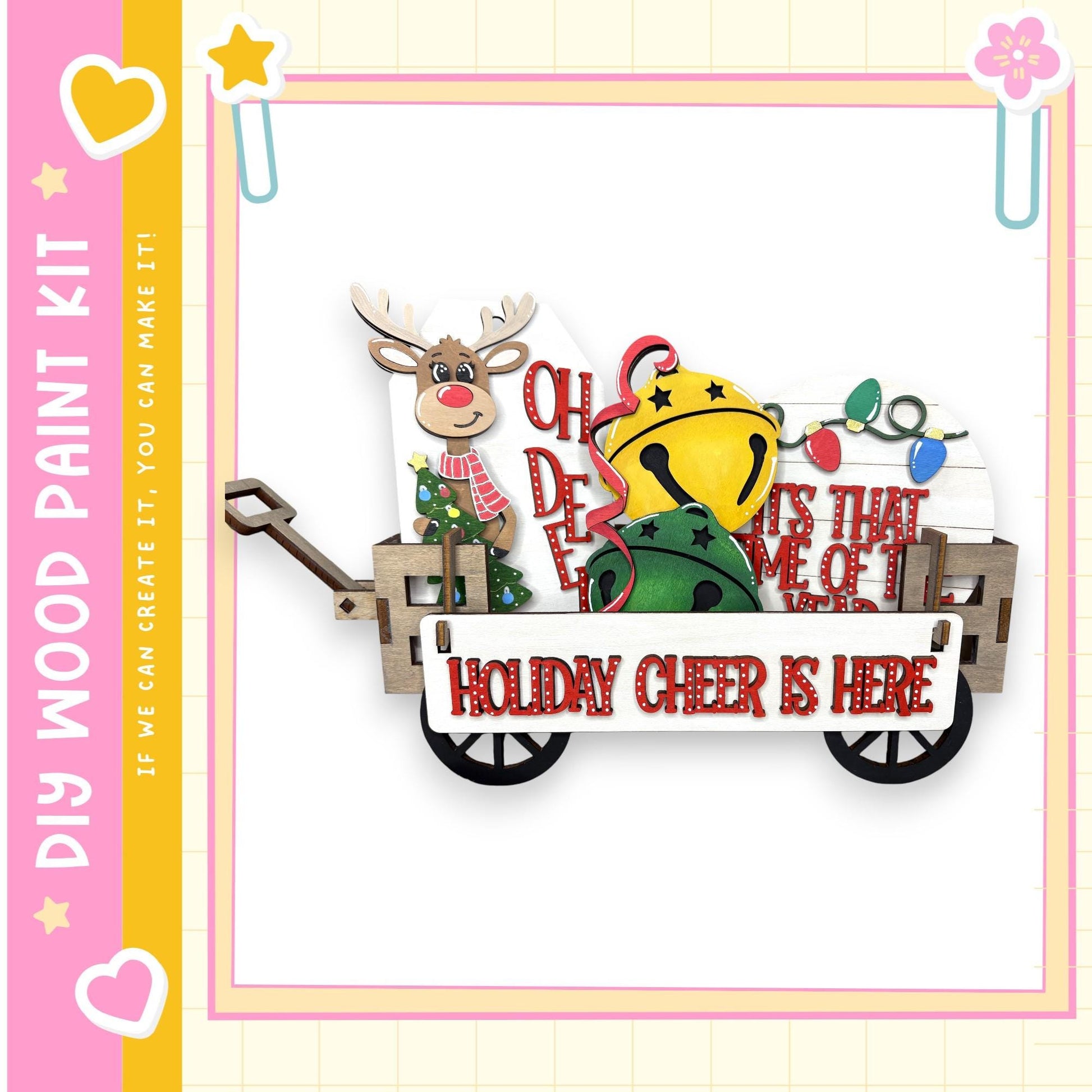 A wooden wagon decorated with holiday-themed items, including a reindeer, bells, and a sign that says "HOLIDAY CHEER IS HERE".
