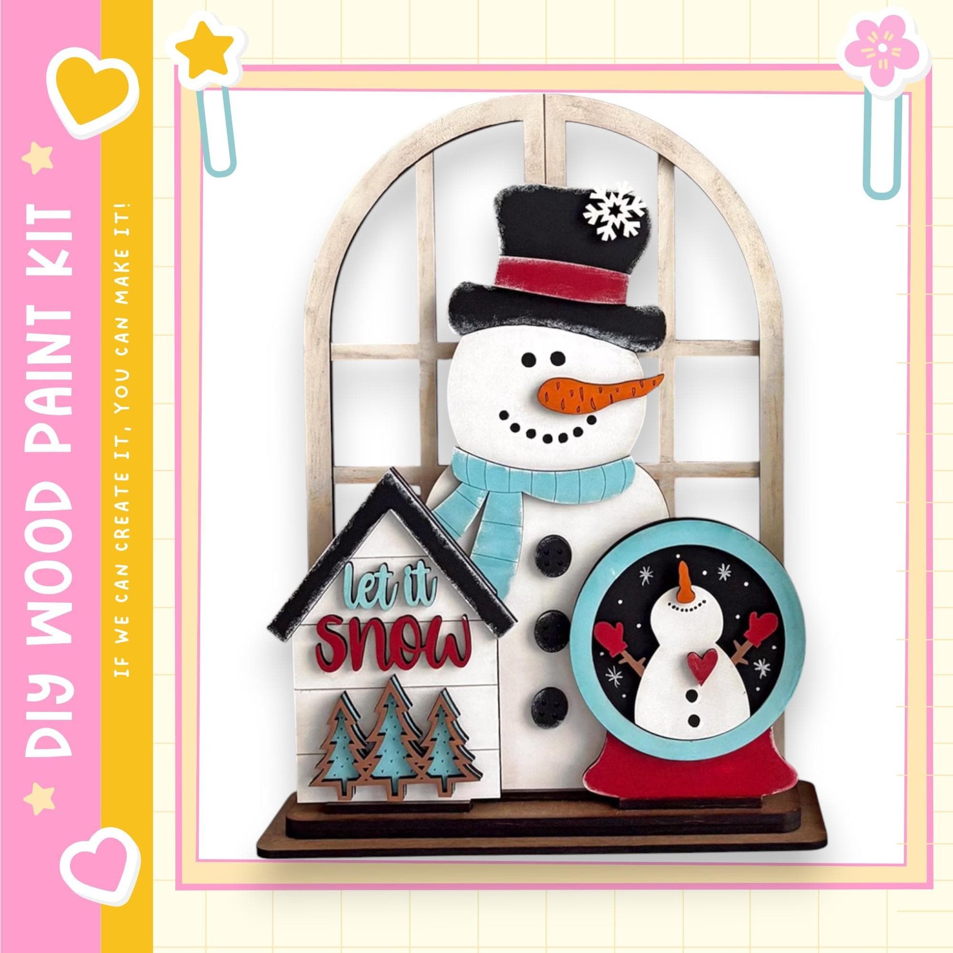 A snowman and a snow globe are displayed in a decorative arrangement, with a sign that says "let it snow" and a heart-shaped sticker.