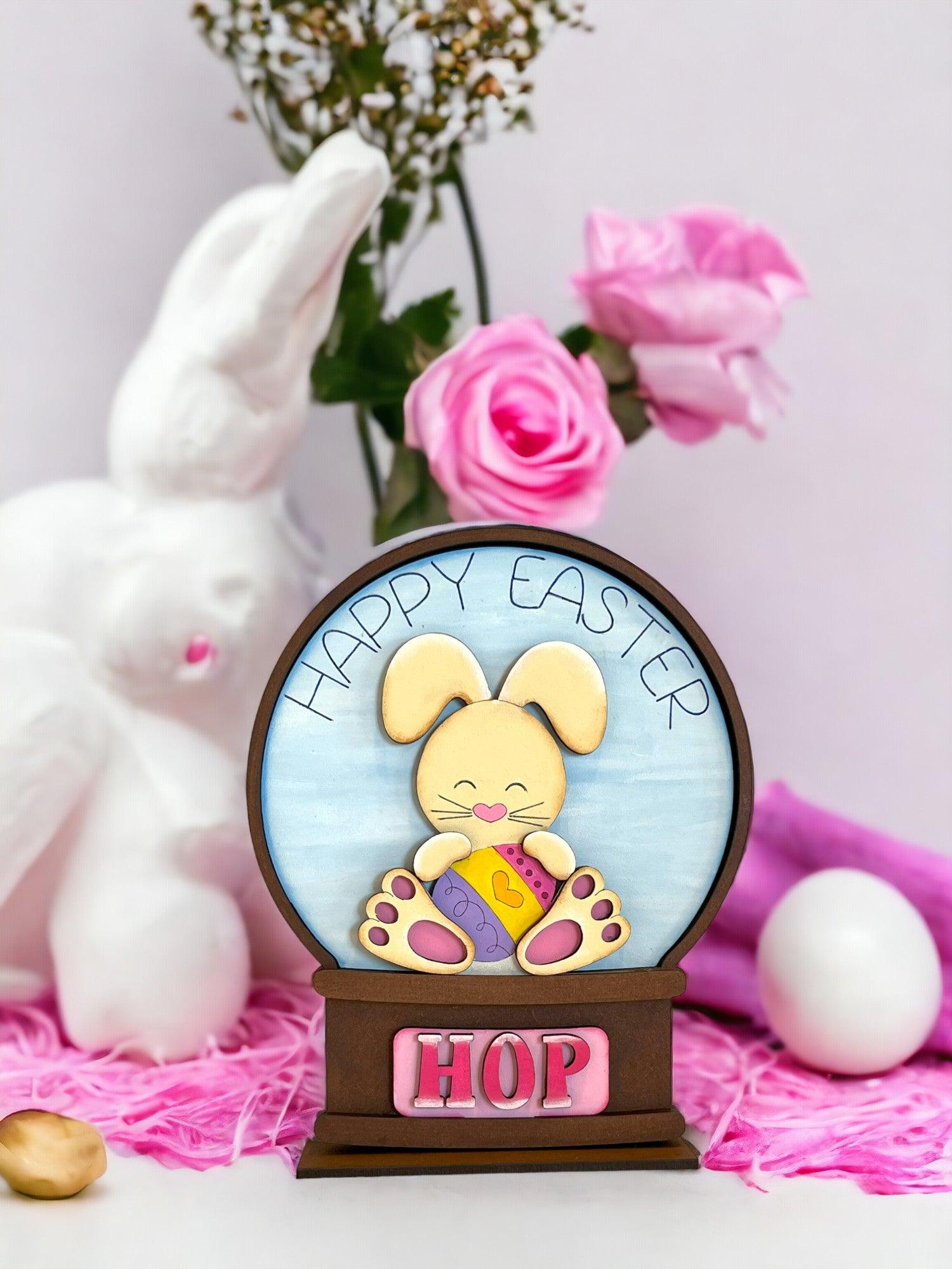 a wooden sign with a bunny holding an egg