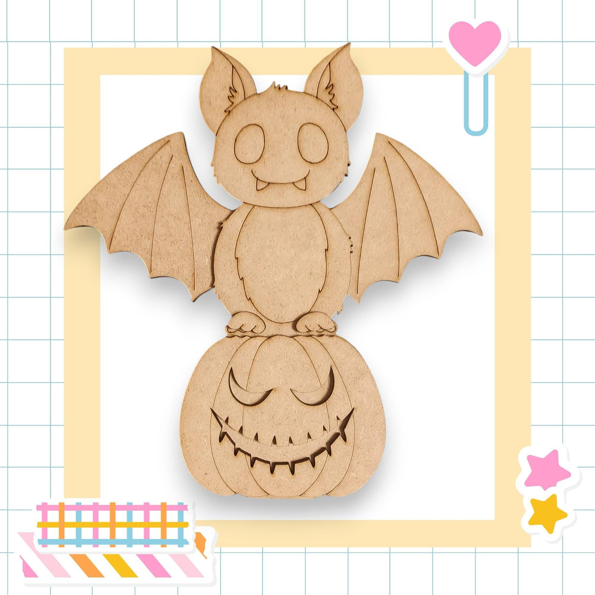 A wooden bat with a carved face is perched on a carved pumpkin, surrounded by colorful stickers and a heart-shaped object.