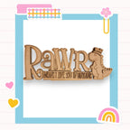 a wooden brooch with the words rawr on it