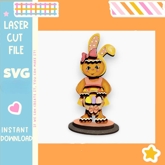 a wooden toy bunny wearing a pink dress and bow, standing on a black base.