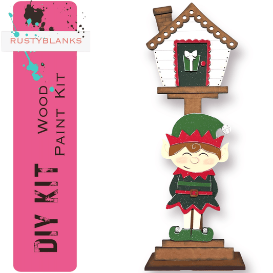 a wooden christmas decoration with a house and a elf