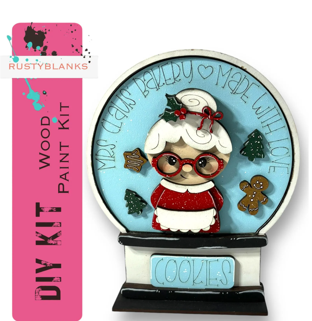 A DIY paint kit for creating a Christmas-themed snow globe, featuring a small figurine of Santa Claus and various holiday-themed decorations.