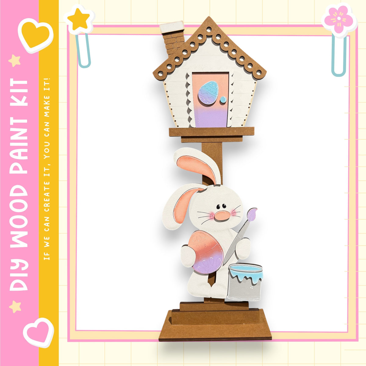 A wooden birdhouse with a painted rabbit figure on top, set against a pink and yellow background with decorative elements.