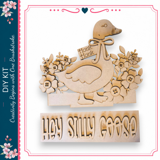 A wooden craft depicting a goose with a bow and flowers, accompanied by the text "Hey Silly Goose"