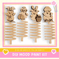 a DIY wood paint kit with four wooden Easter egg ornaments, each with unique designs and decorations.
