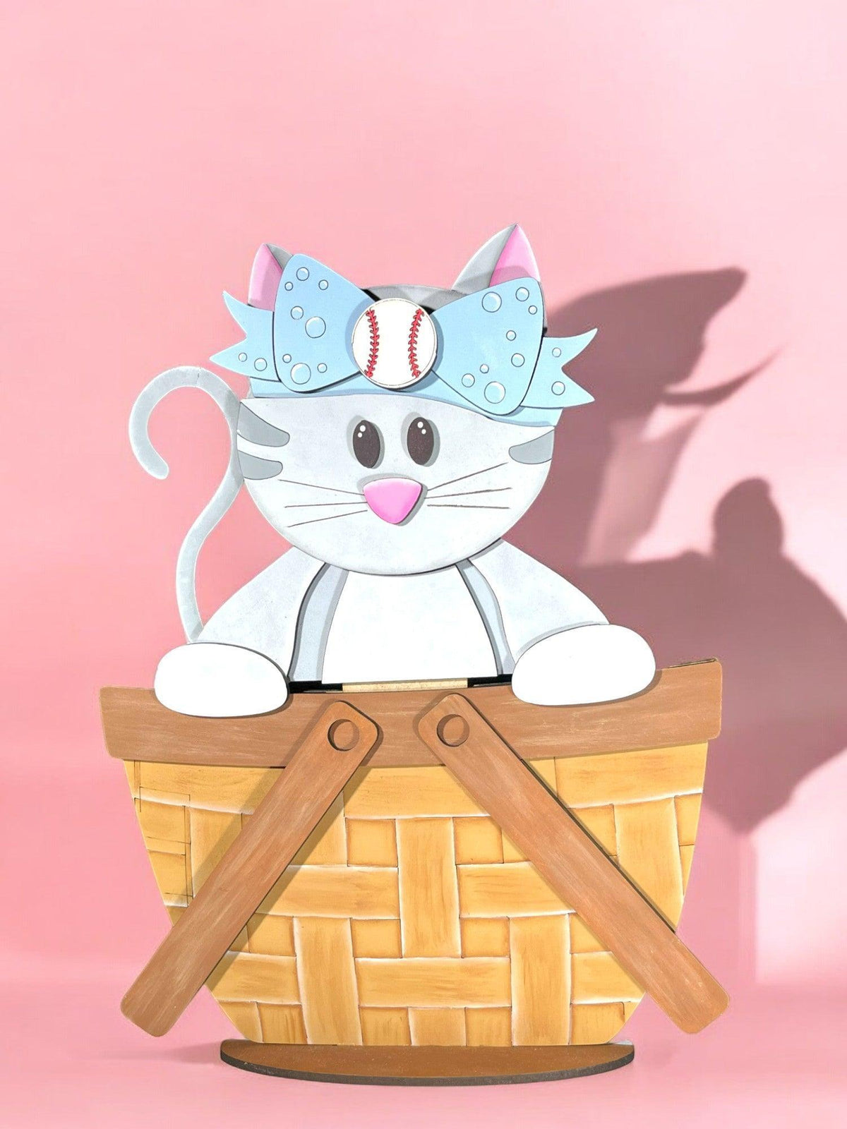 a paper cut out of a cat sitting in a basket