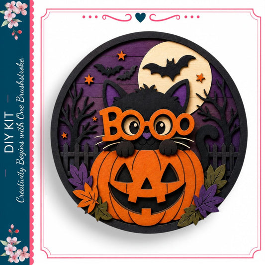 A Halloween-themed cutout featuring a cat peeking out from behind a carved pumpkin, with a full moon, bats, and leaves in the background.