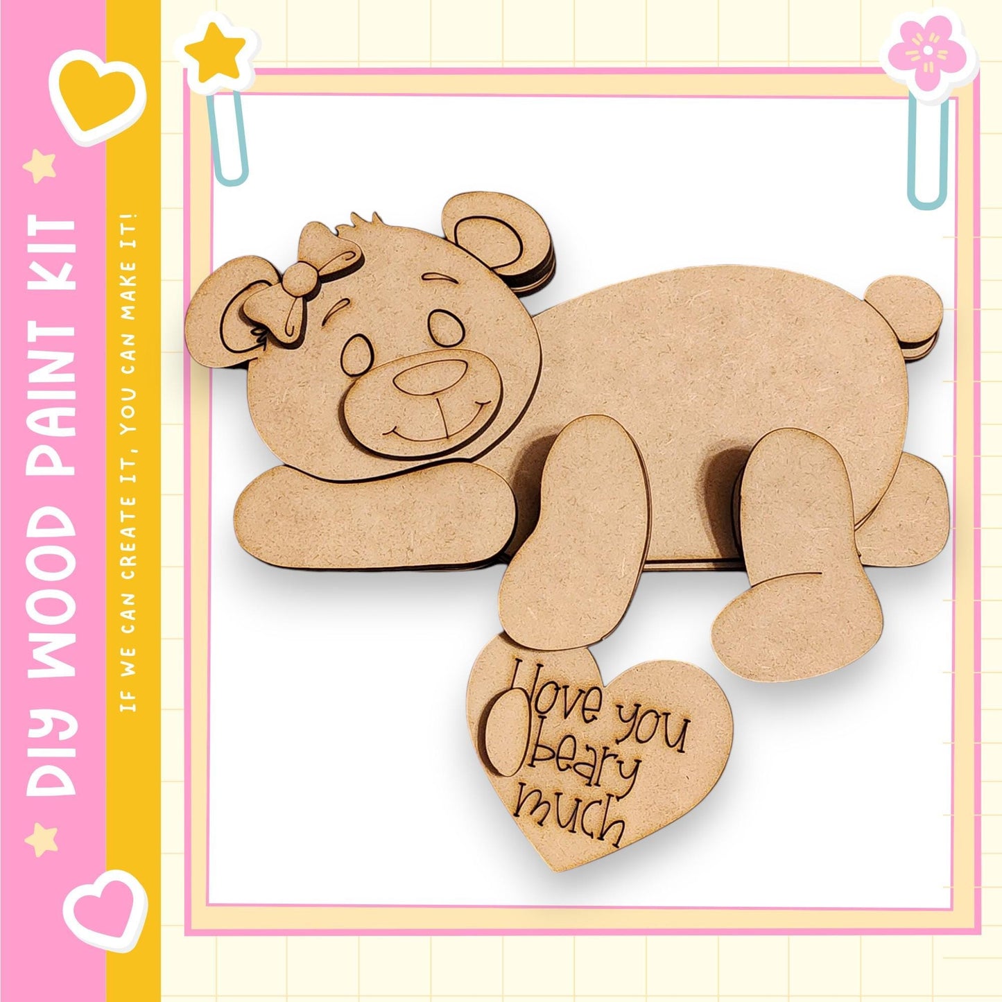 A wooden bear figure with a heart-shaped message attached to it, set against a pink and yellow background.