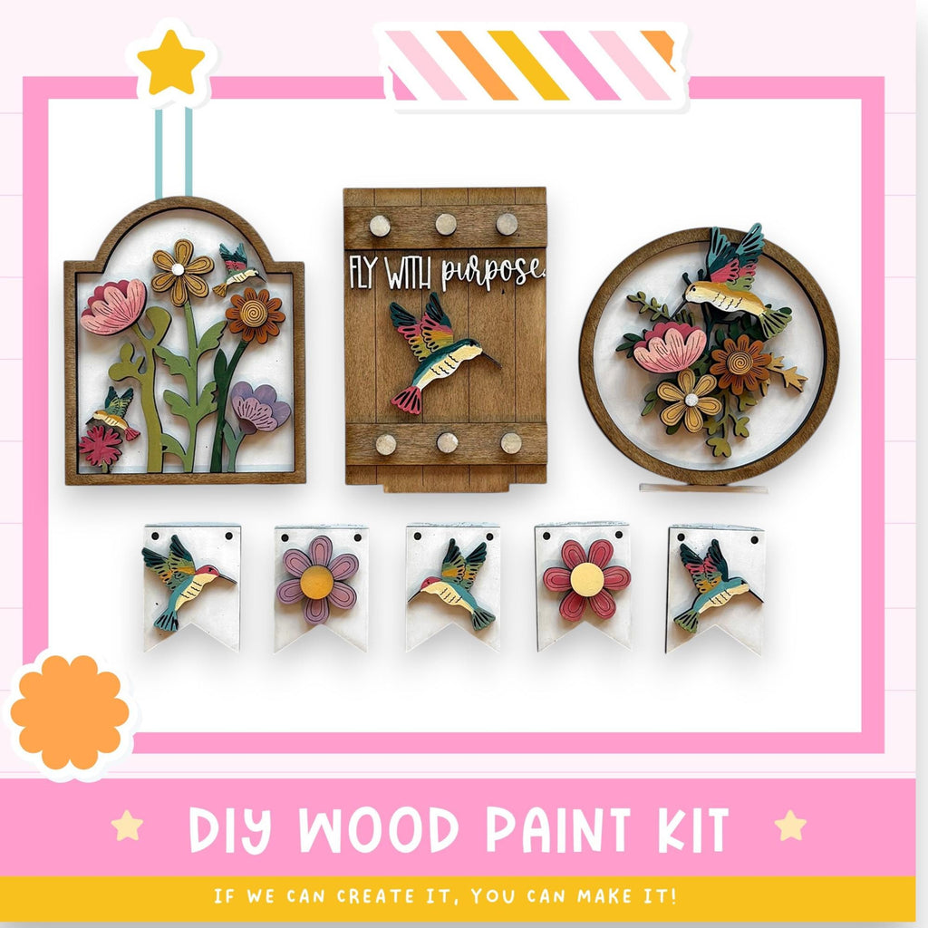 The image is a DIY wood paint kit featuring various wooden decorations and bird-themed elements, including a wooden frame with a bird and flowers, a wooden birdhouse, and a wooden birdhouse with flowers. The kit appears to be designed for creating custom wooden decorations and birdhouses.